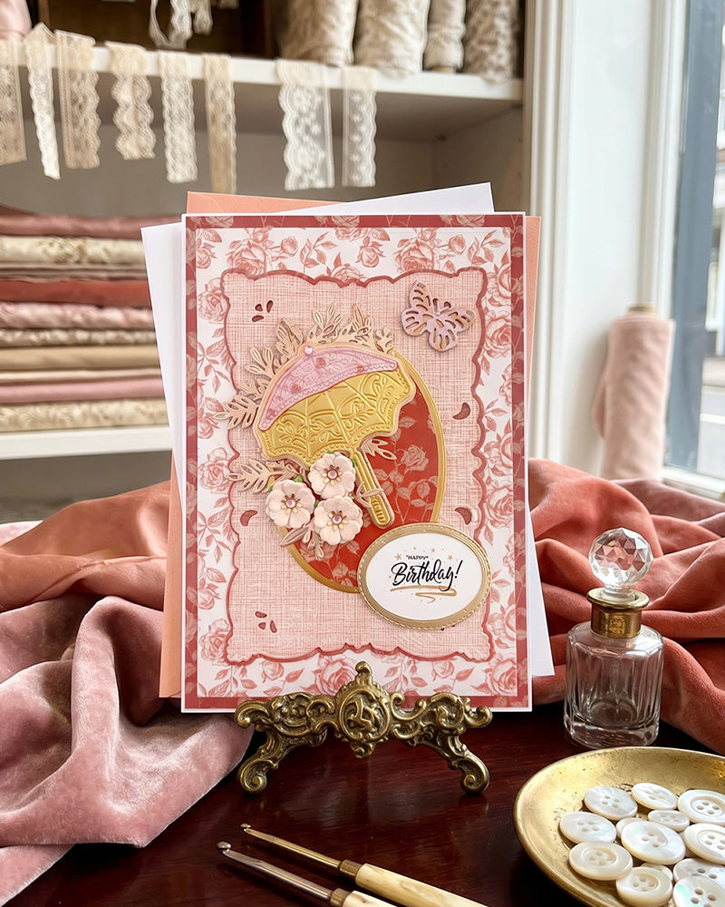 A handmade birthday card with elegant floral embellishments, made in New Zealand by Del Cards