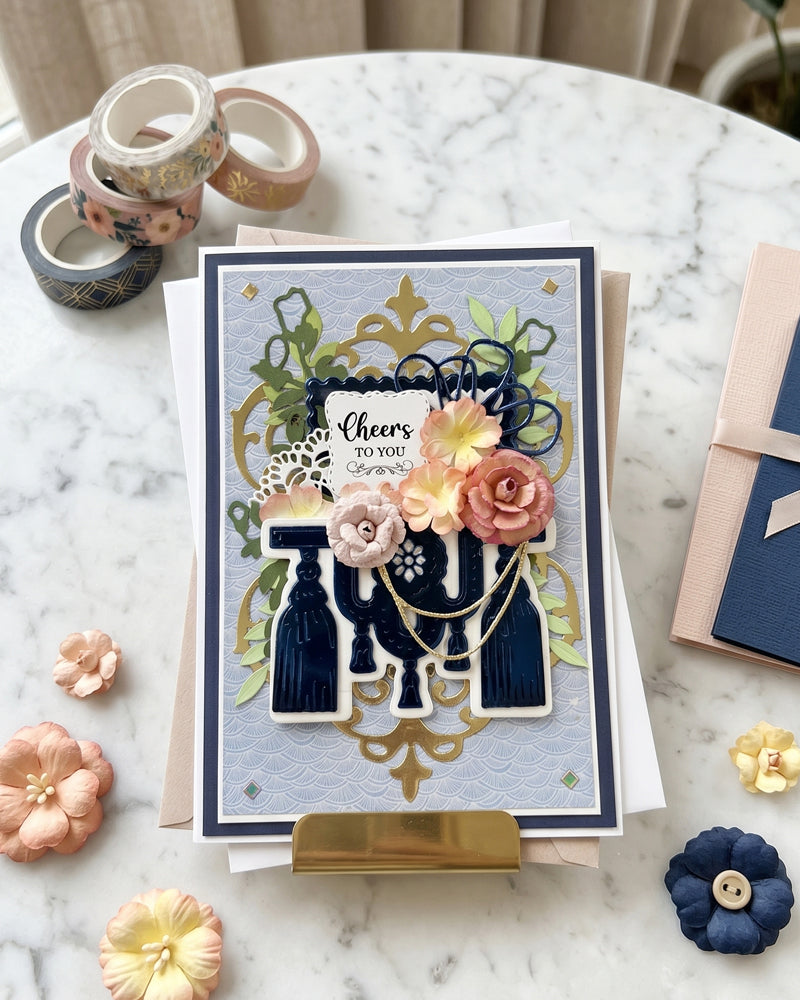 Beautiful celebration card displayed flat in a styled overhead setting with wax seals and dried flower props alongside. Rich navy, gold and blush tones make this an elegant handmade card for birthdays, milestones or congratulations, made in New Zealand by Del Cards NZ.