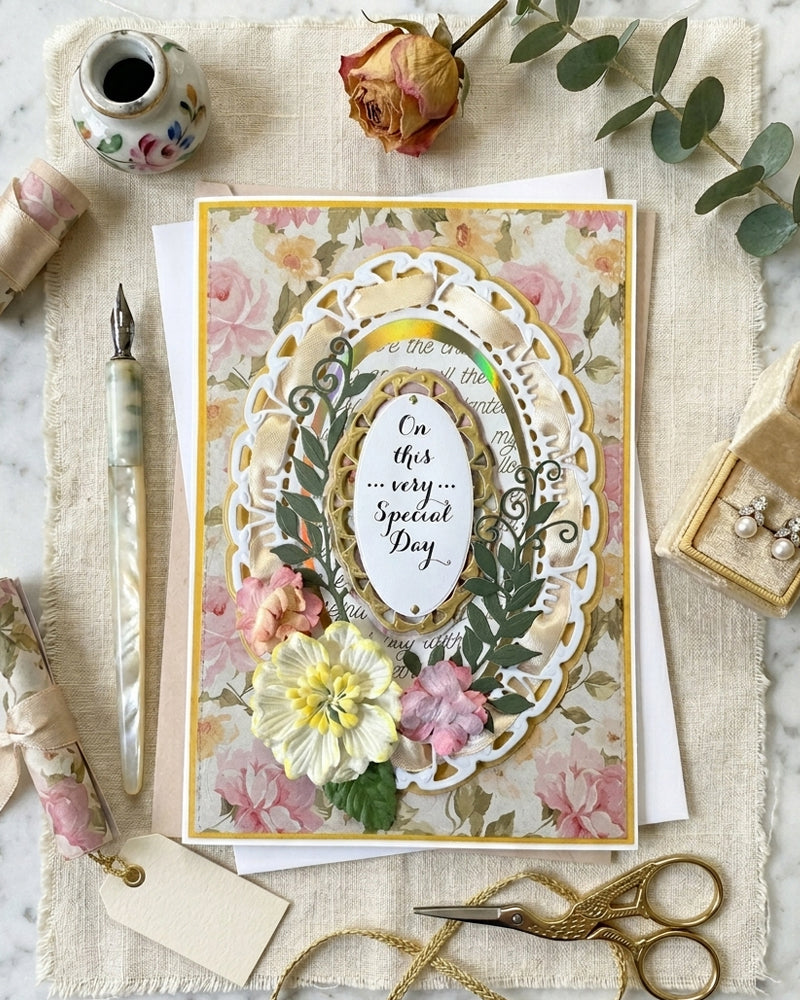 Decorative greeting card with floral design and text on a textured surface with stationery items, made by Del Cards NZ