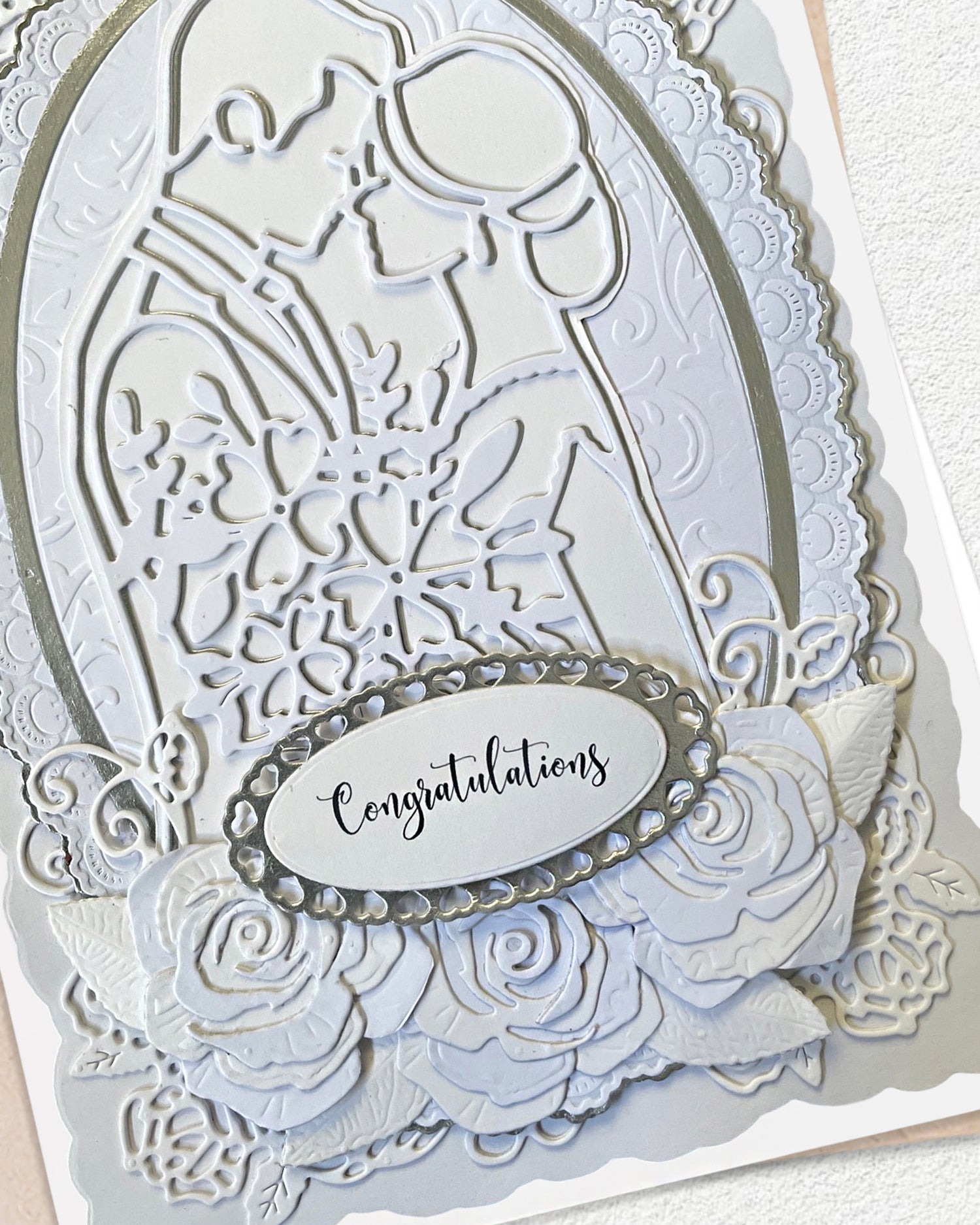 Detail shot of luxury handmade wedding card by Del Cards NZ, intricate layered papers and fine gems