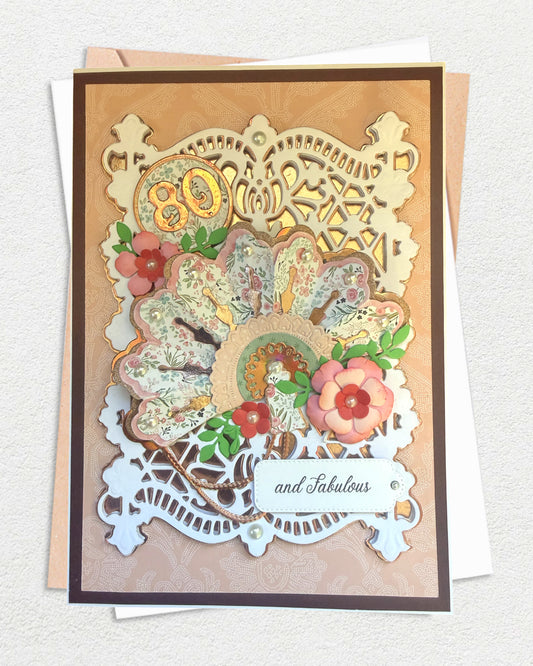 A luxury handmade birthday card with floral elements and '80 and Fabulous' text on a white background, made in New Zealand by Del Cards NZ