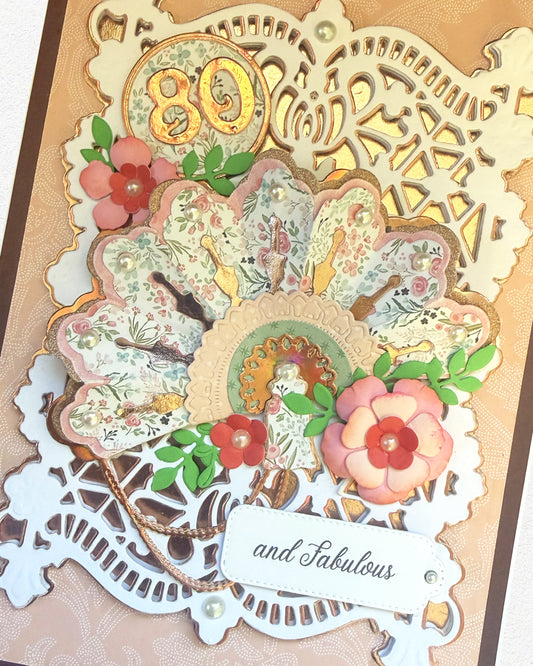 Details of handmade birthday card with floral elements and '80 and Fabulous' text on a white background, made in New Zealand by Del Cards NZ