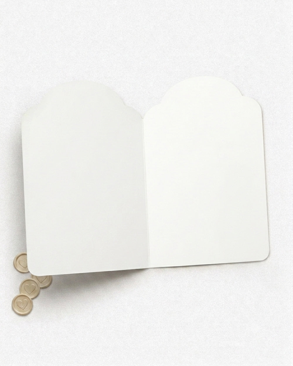 The inside of the mini card made by Del Cards NZ. It is shown open on a light gray background. Blank inside.