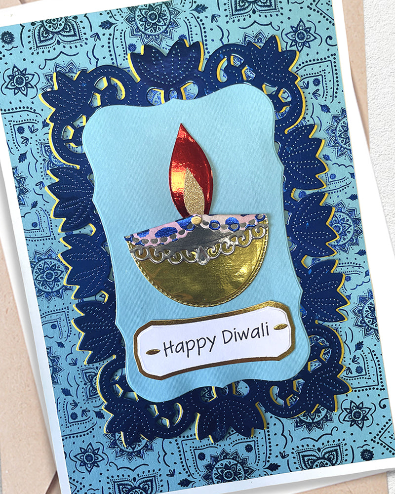 Detail shot of handmade Diwali card by Del Cards NZ, blue foil embellishments and premium materials
