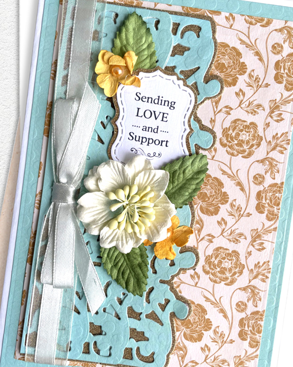 Detail shot of handmade love and support card by Del Cards NZ, premium layered papers and elegant embellishments
