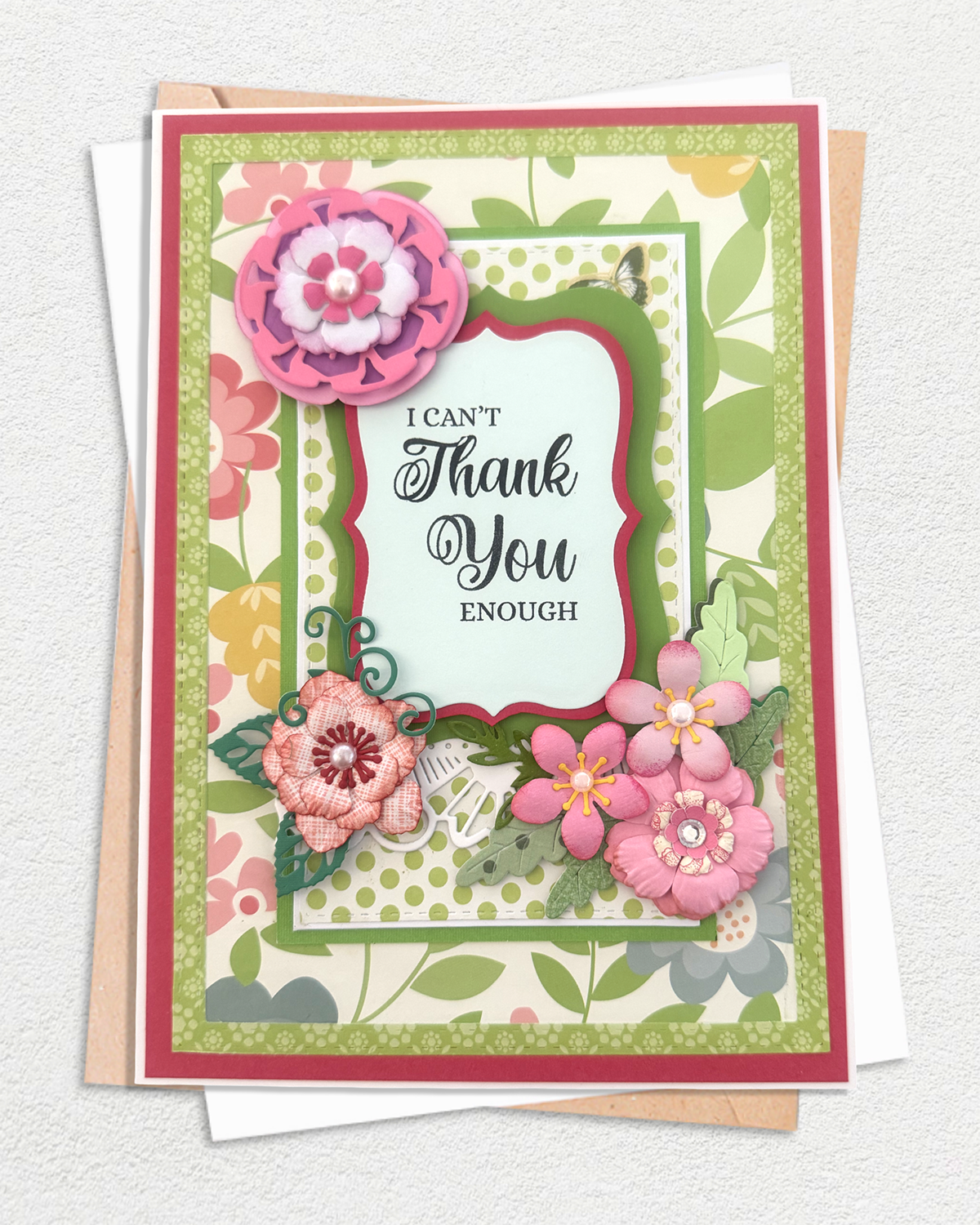 Handmade floral thank you card with pink paper rosette, red frame and botanical green paper, made by Del Cards NZ.