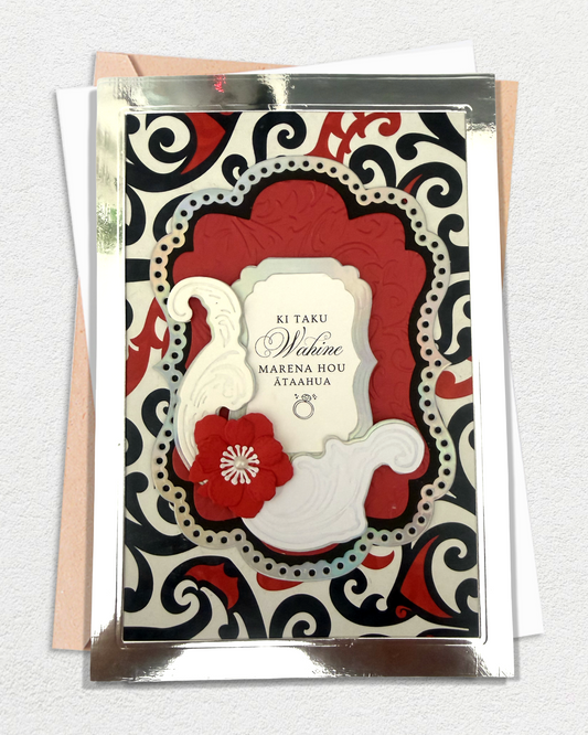 Luxury handmade Te Reo Māori wedding card with floral design and traditional red and black patterned background, made in Auckland New Zealand