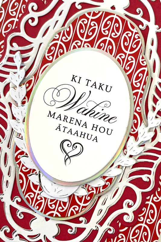 Close up detail of luxury handmade Māori wedding card by Del Cards NZ, red and black patterned design with fine embellishments
