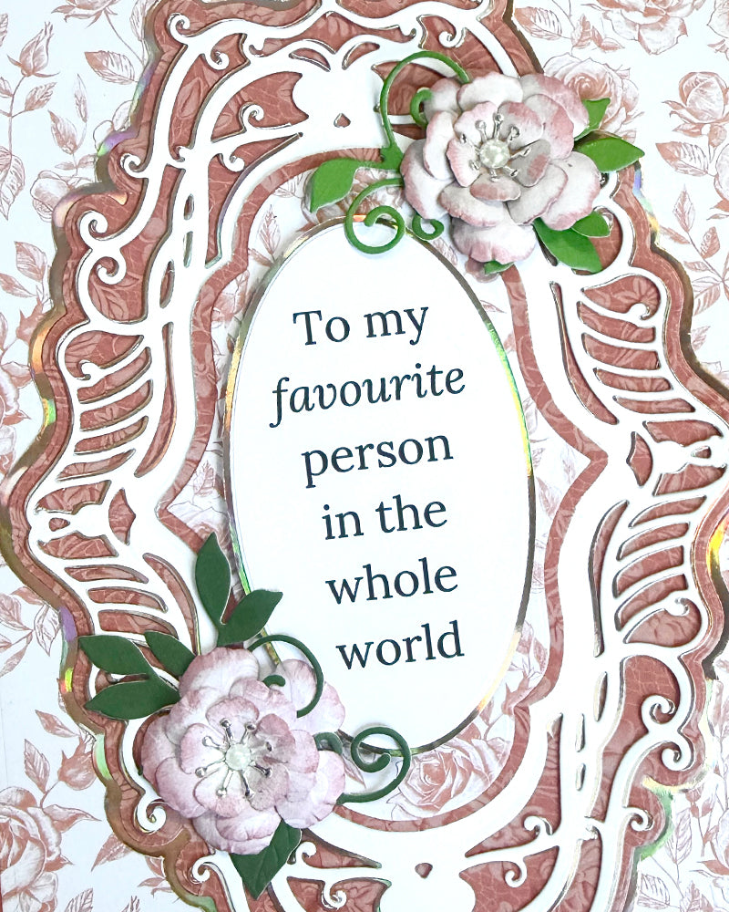 Decorative card with floral elements and text 'To my favourite person in the whole world' on a white background.