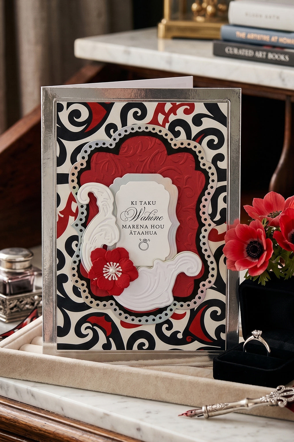 Amazing handmade Te Reo Māori wedding card with floral design and traditional red and black patterned background, made in New Zealand by Del Cards