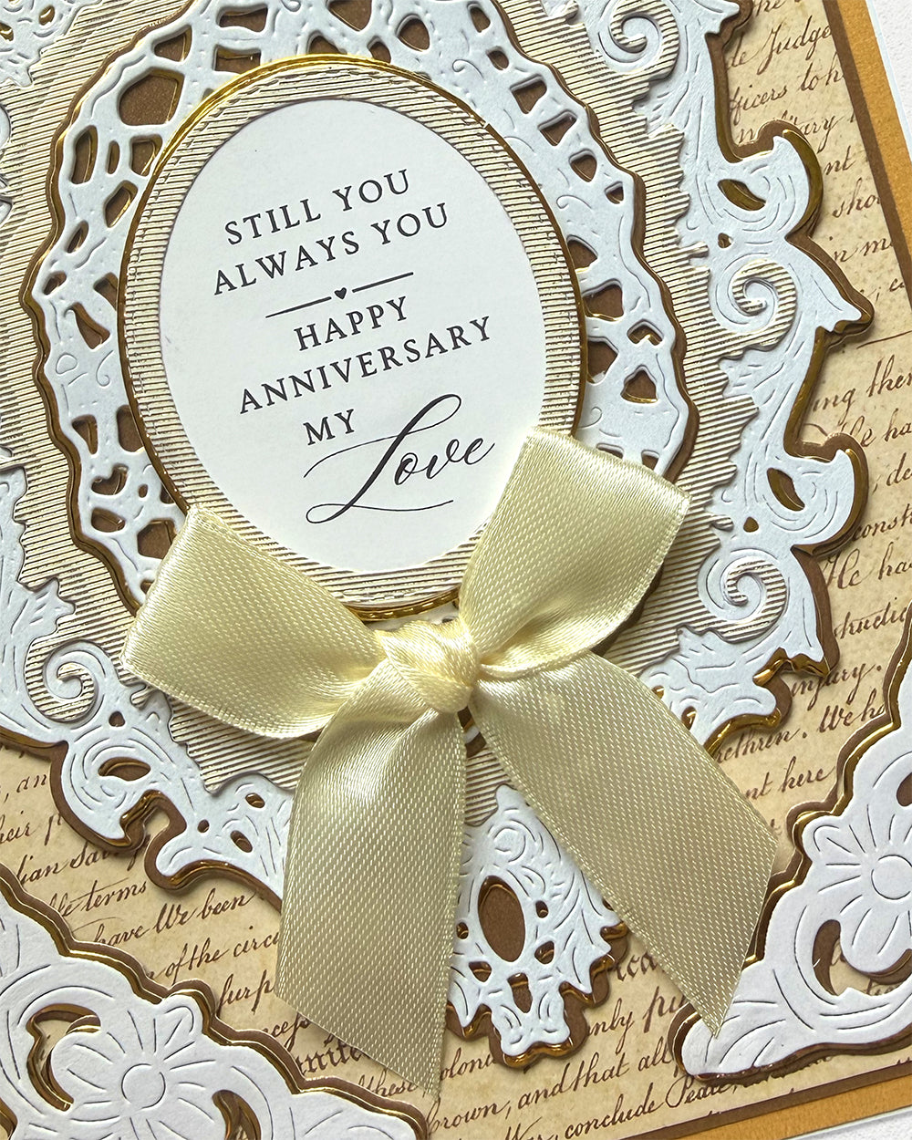 Detailed shot of Handmade anniversary card in gold and white details and a ribbon, made in New Zealand by Del Cards NZ.