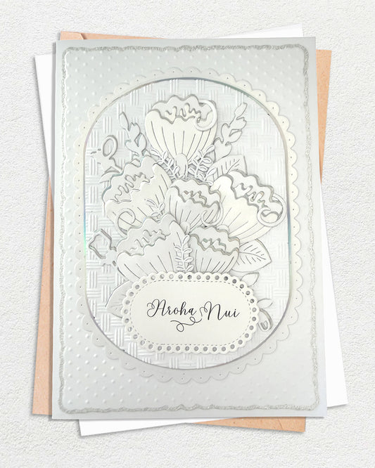 Luxury embossed handmade card with dimensional foiled floral design and "Aroha Nui" te reo Māori greeting meaning much love, by Del Cards NZ

