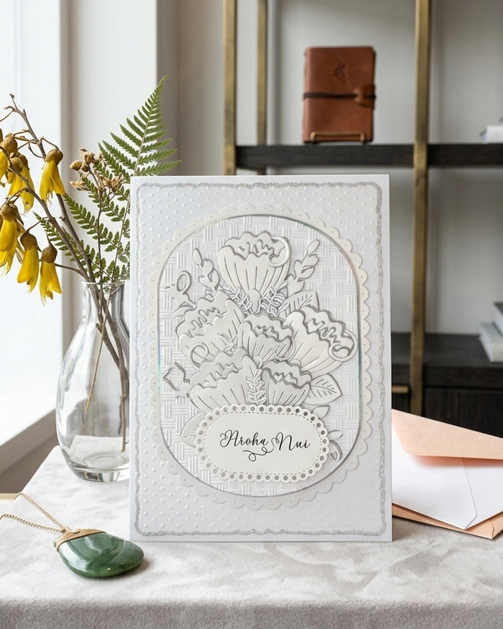 Luxury Handmade embossed card with dimensional foiled floral design and "Aroha Nui" te reo Māori greeting meaning much love, by Del Cards NZ
