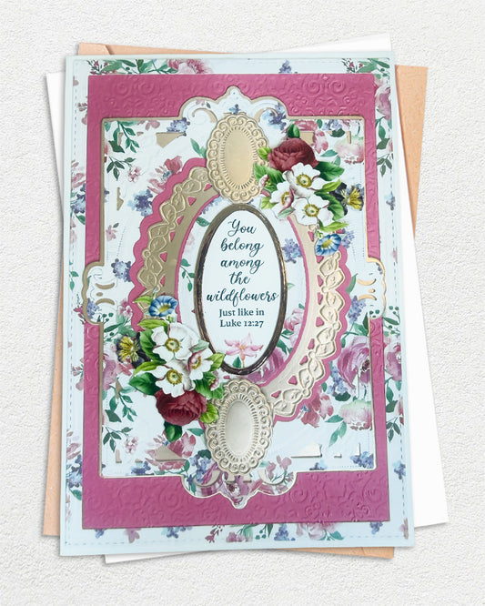 Handmade Christian greeting card in deep rose pink and gold, with floral paper, gold oval die-cut frame and Luke 12:27 sentiment, made in New Zealand