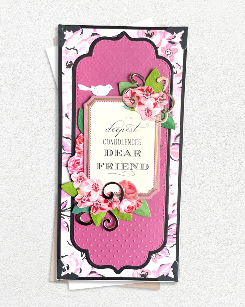 Handmade luxury condolence card with pink floral layers, cream sentiment panel reading "Deepest Condolences Dear Friend", handcrafted in New Zealand