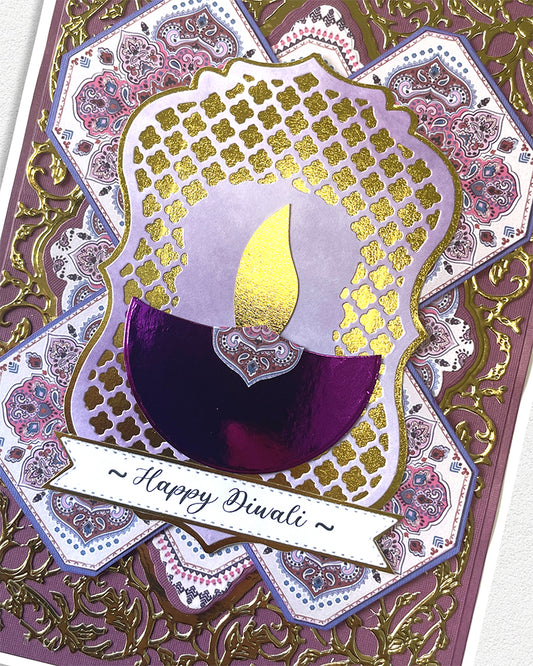 Decorative card with a Diwali candle design and 'Happy Diwali' text on a patterned background.
