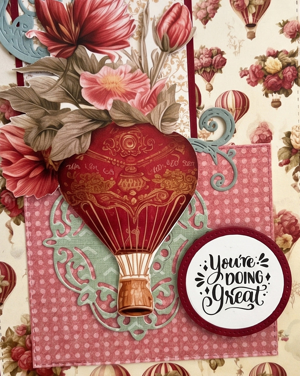 Full front view of a handmade vintage-style encouragement card featuring a floral and hot air balloon patterned background, pink gingham centre panel, dimensional red and gold balloon, large pink dahlia and a "You're doing Great" circular sentiment. A uplifting handmade card made in New Zealand — ideal for encouragement, get well, new job or milestone occasions.
