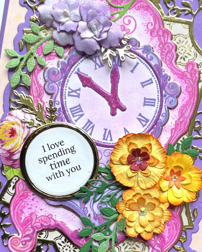 Close-up of circular sentiment panel reading "I love spending time with you" surrounded by dimensional floral die-cuts in yellow, pink and purple