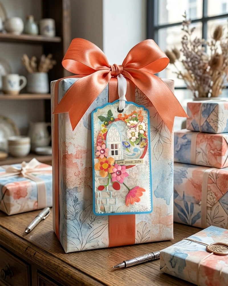 Luxury handmade gift tag styled on a wrapped gift with burnt orange satin bow and dried botanicals — Del Cards NZ handmade gift tags are perfect for birthdays, celebrations and everyday moments of joy