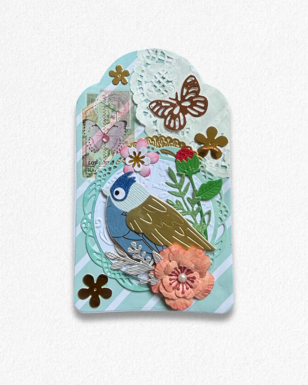 Handmade mini card by Del Cards NZ featuring a die-cut bird with floral details on a mint striped background.