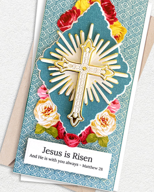 Close-up of handmade Easter card showing layered gold cross and sunburst die-cut detail over teal diamond panel