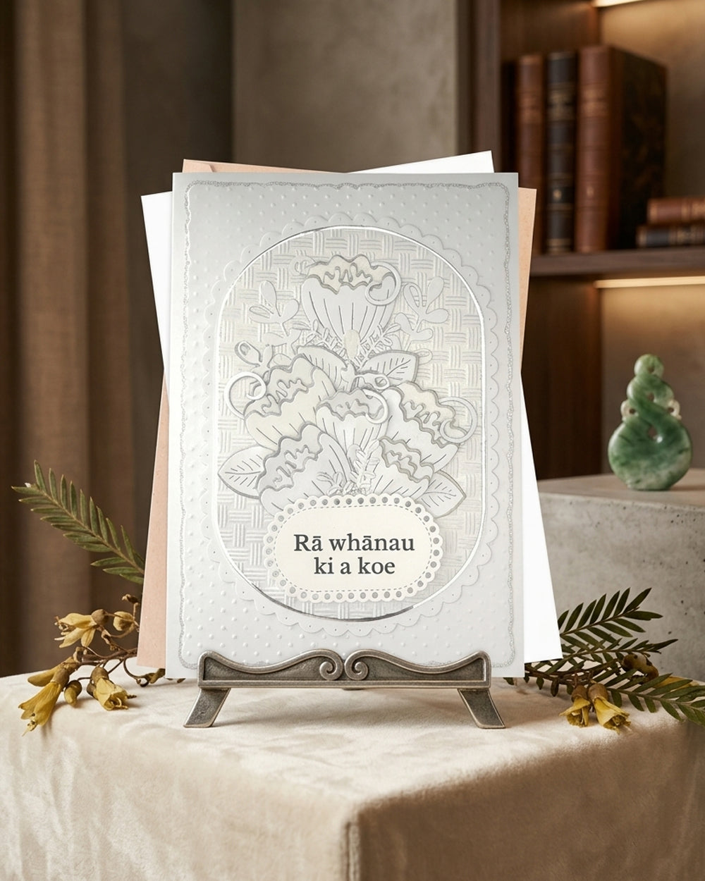 Whiteembossed handmade birthday card with dimensional foiled floral design and "Rā whānau ki a koe" te reo Māori greeting, by Del Cards NZ
