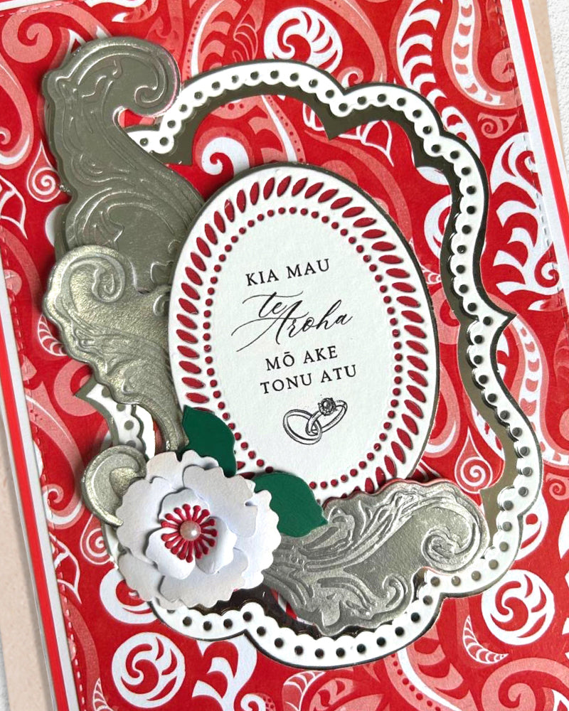 Detail shot of luxury handmade Māori wedding card by Del Cards NZ, fine gems and elegant traditional patterning