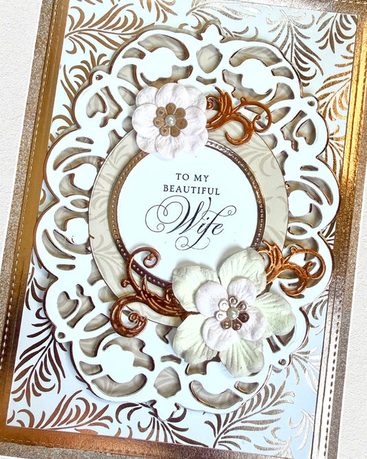 Decorative card with floral designs and 'To my beautiful wife' text on a white background